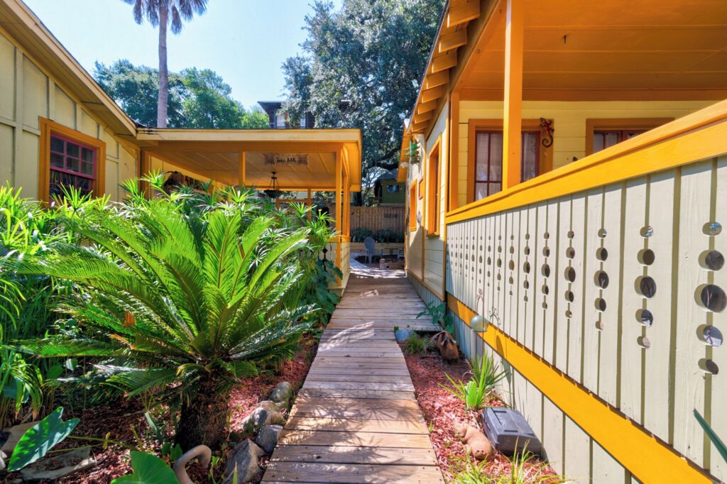 Garden walkway past palms to the cottages at Beachside Boutique Inn