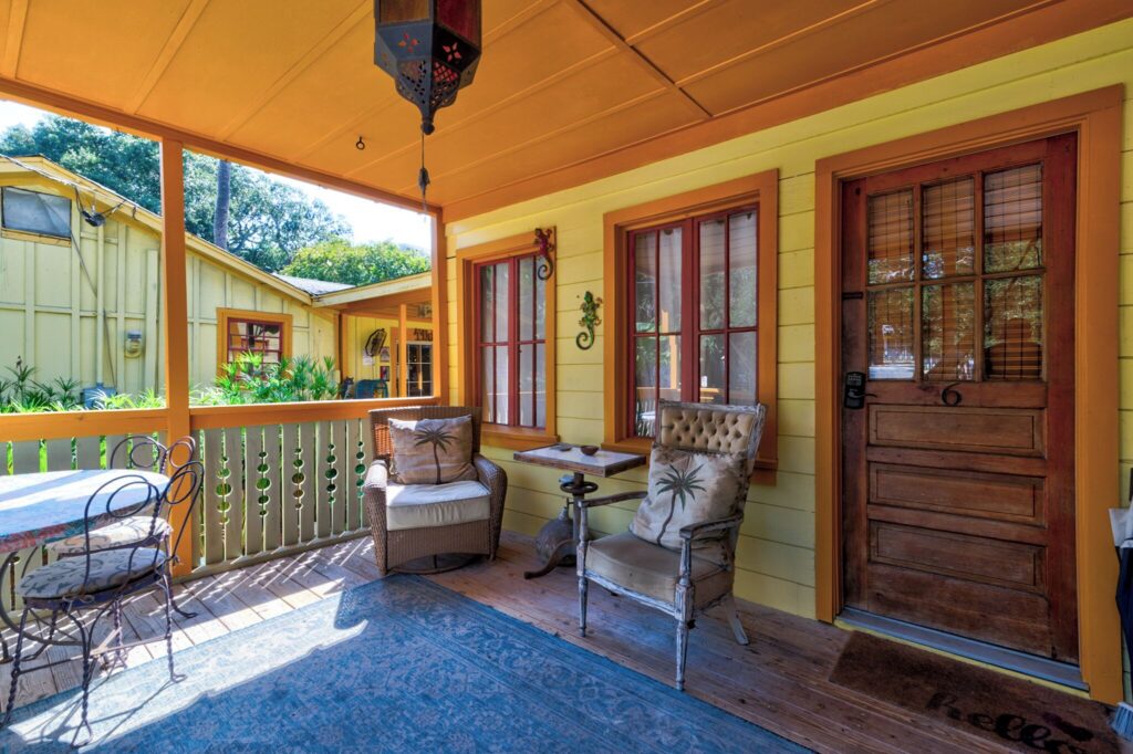 Screened porch with rocking chairs at Beachside Boutique Inn