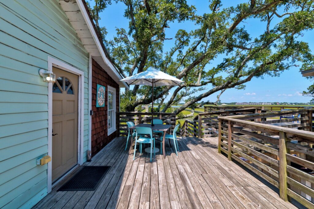 Wooden deck under the oaks at Riverside Inn
