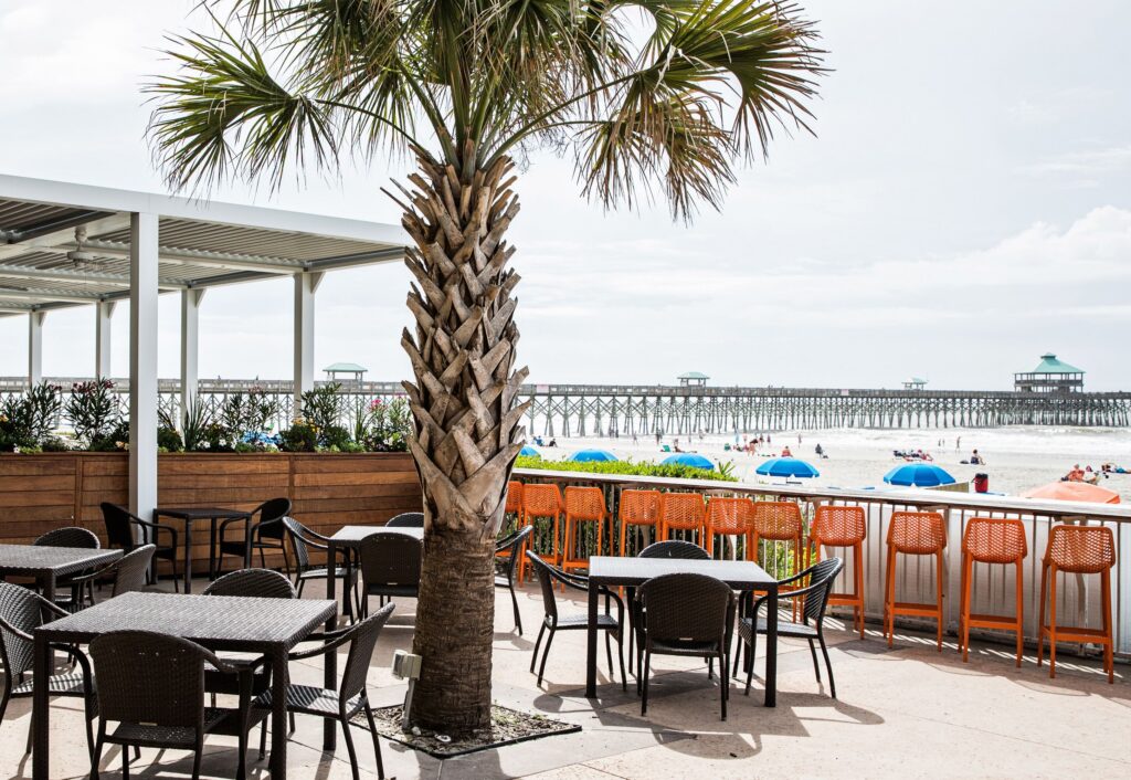 Oceanfront patio seating at Tides Folly Beach