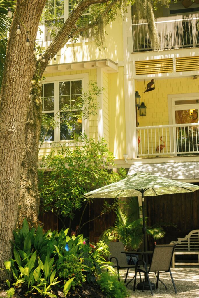 Garden patio with an umbrella outside Water’s Edge Inn