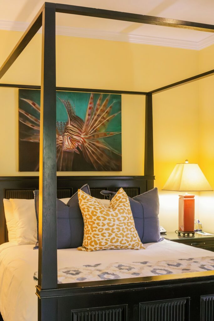 Guest room with a king bed and bold artwork at Water’s Edge Inn